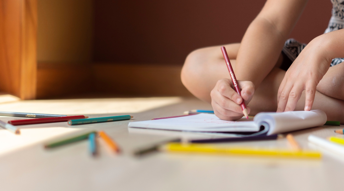 Child drawing with pencils